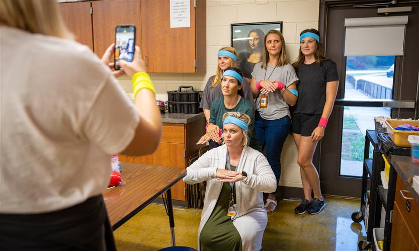 Teachers take a picture in the art room at Scales Elementary